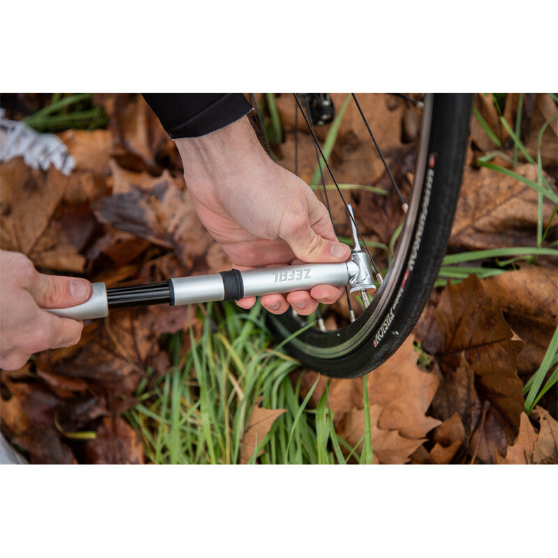 Load image into Gallery viewer, ZEFAL Pump Road Micro High Performance 165mm Silver in use on a bicycle tire outdoors.